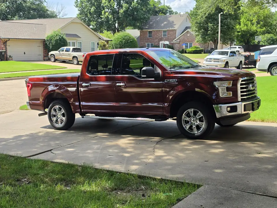 Red Ford F-150 in a driveway after a Tiger Auto Spa detail